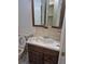 Bathroom featuring a toilet and sink with a medicine cabinet and a tiled floor at 18249 E Mexico Pl, Aurora, CO 80017
