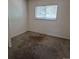 Bedroom featuring neutral carpet, white walls, and a small window with blinds at 18249 E Mexico Pl, Aurora, CO 80017