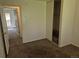 Bedroom featuring neutral carpet, white walls, built in closet space, and a door to another room at 18249 E Mexico Pl, Aurora, CO 80017