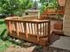 A wooden deck with stairs is surrounded by grass and trees in the backyard at 18249 E Mexico Pl, Aurora, CO 80017