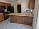 Functional kitchen design with peninsula island, ample counter space, and stainless steel sink at 18249 E Mexico Pl, Aurora, CO 80017