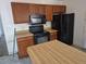 The kitchen provides a microwave and island for storage, food prep, and cooking space at 18249 E Mexico Pl, Aurora, CO 80017