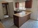 Kitchen with a peninsula island, a built-in sink, and storage at 18249 E Mexico Pl, Aurora, CO 80017