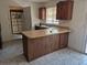 Kitchen with a peninsula, providing additional counter space and a built-in sink at 18249 E Mexico Pl, Aurora, CO 80017