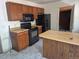 Kitchen features an island, wood cabinets, and updated appliances for the home chef at 18249 E Mexico Pl, Aurora, CO 80017
