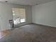 View of an expansive living room with plush carpeting and sunlit window, and vacuum present at 18249 E Mexico Pl, Aurora, CO 80017