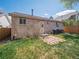 Backyard features brick home, grass, small patio, and BBQ grill at 4151 S Lewiston Cir, Aurora, CO 80013