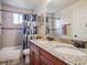 Spacious bathroom with dual sinks, tile floor, and bathtub with shower at 4151 S Lewiston Cir, Aurora, CO 80013