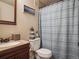 Cozy bathroom featuring a mirror, toilet and vanity with a light-colored countertop at 4151 S Lewiston Cir, Aurora, CO 80013