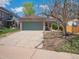 Home featuring a two-car garage with a brick facade and concrete driveway at 4151 S Lewiston Cir, Aurora, CO 80013