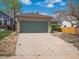 Home featuring a two-car garage with a brick facade and concrete driveway at 4151 S Lewiston Cir, Aurora, CO 80013