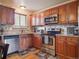 Cozy kitchen with wooden cabinets, stainless steel appliances and granite countertops at 4151 S Lewiston Cir, Aurora, CO 80013