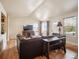 A naturally lit living room with hardwood floors and a large sectional couch at 4151 S Lewiston Cir, Aurora, CO 80013
