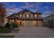 Inviting two-story home with a three car garage, stone accents, and mature landscaping at 7054 S Fultondale Cir, Aurora, CO 80016