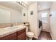 Cozy bathroom featuring a vanity and sink, toilet, and laundry appliances on hardwood flooring at 3744 Gypsum Ct, Superior, CO 80027