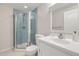Bright bathroom featuring a mosaic tiled shower, white vanity and ample lighting at 3744 Gypsum Ct, Superior, CO 80027