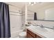 Well lit bathroom featuring a shower over the tub, vanity, and neutral colored walls at 3744 Gypsum Ct, Superior, CO 80027