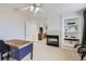 Bright bedroom offering a fireplace, ceiling fan, large windows, and space for a desk and dresser at 3744 Gypsum Ct, Superior, CO 80027