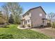 Back exterior view of home featuring a patio, lush lawn, and mature trees at 3744 Gypsum Ct, Superior, CO 80027