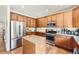 Traditional kitchen featuring stainless appliances, granite countertops, and wood flooring at 3744 Gypsum Ct, Superior, CO 80027