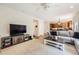 Inviting living room featuring a ceiling fan, media center, and opening to the kitchen with hardwood flooring at 3744 Gypsum Ct, Superior, CO 80027