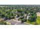 Panoramic aerial view of a residential area with lush green trees and well-maintained landscaping at 14230 Lakeview Ln, Broomfield, CO 80023
