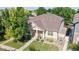 Beautiful home with lush landscaping and a well-manicured lawn, surrounded by mature trees at 14230 Lakeview Ln, Broomfield, CO 80023
