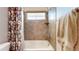 Cozy bathroom featuring tub with shower and floral shower curtain at 14230 Lakeview Ln, Broomfield, CO 80023