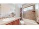 Charming bathroom with tile backsplash, tub with shower, and dark-stained wood cabinet at 14230 Lakeview Ln, Broomfield, CO 80023