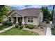 Well-maintained home with a stone-accented facade, covered entry, and fresh landscaping at 14230 Lakeview Ln, Broomfield, CO 80023