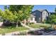 Charming home with a welcoming front porch, lush landscaping, and a vibrant green lawn at 14230 Lakeview Ln, Broomfield, CO 80023