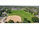 Scenic view of a large green school field, baseball diamond, and school building at 14230 Lakeview Ln, Broomfield, CO 80023