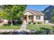 Charming single-story home featuring a cozy front porch, well-maintained landscaping, and a welcoming entrance, perfect for Gathering living at 14230 Lakeview Ln, Broomfield, CO 80023