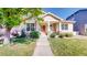 Charming single-story home featuring a welcoming front porch, manicured lawn, and lovely landscaping at 14230 Lakeview Ln, Broomfield, CO 80023