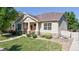 Charming home featuring a welcoming front porch and well-maintained landscaping, with stone accents at 14230 Lakeview Ln, Broomfield, CO 80023