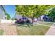 Lush front yard with mature tree and well-maintained grass of a charming home at 14230 Lakeview Ln, Broomfield, CO 80023