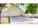 Detached two-car garage featuring a large concrete parking pad and an adjacent fenced yard at 14230 Lakeview Ln, Broomfield, CO 80023