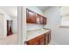 Laundry room featuring cherry-stained cabinets and lots of counter space at 14230 Lakeview Ln, Broomfield, CO 80023