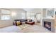 Comfortable living room featuring a fireplace, carpeted floors, and natural light from large windows at 14230 Lakeview Ln, Broomfield, CO 80023