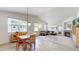 Open-concept living room and dining area with fireplace and lots of natural light at 14230 Lakeview Ln, Broomfield, CO 80023