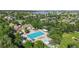 Aerial view of a beautiful pool and amenity center surrounded by trees and community at 14230 Lakeview Ln, Broomfield, CO 80023
