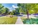 A charming street featuring well-maintained lawns and tree-lined sidewalks at 14230 Lakeview Ln, Broomfield, CO 80023