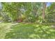 A lush green backyard with a lawn, mature trees, and a wooden staircase leading to a higher area at 800 Illinois St # 1, Golden, CO 80401