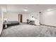 A bright basement with neutral carpet, bright lighting, and an optional bedroom and desk setup at 800 Illinois St # 1, Golden, CO 80401