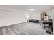 A large basement with neutral carpet, bright lighting, and an optional bedroom and desk setup at 800 Illinois St # 1, Golden, CO 80401