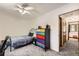 Carpeted bedroom featuring natural lighting, a ceiling fan, and hallway access at 800 Illinois St # 1, Golden, CO 80401
