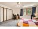 Carpeted bedroom with ceiling fan, windows, and closet space at 800 Illinois St # 1, Golden, CO 80401