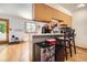Functional eat-in kitchen with natural lighting, bar seating, and wooden cabinets at 800 Illinois St # 1, Golden, CO 80401