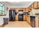 Bright kitchen with modern appliances, wooden cabinets, hardwood floors and a window at 800 Illinois St # 1, Golden, CO 80401