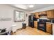 Bright kitchen featuring wood cabinets, black appliances, and natural light at 800 Illinois St # 1, Golden, CO 80401